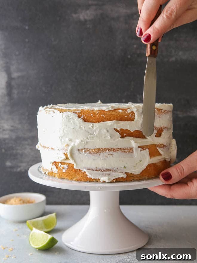 Close-up of a slice of Coconut Lime Layer Cake revealing the curd filling