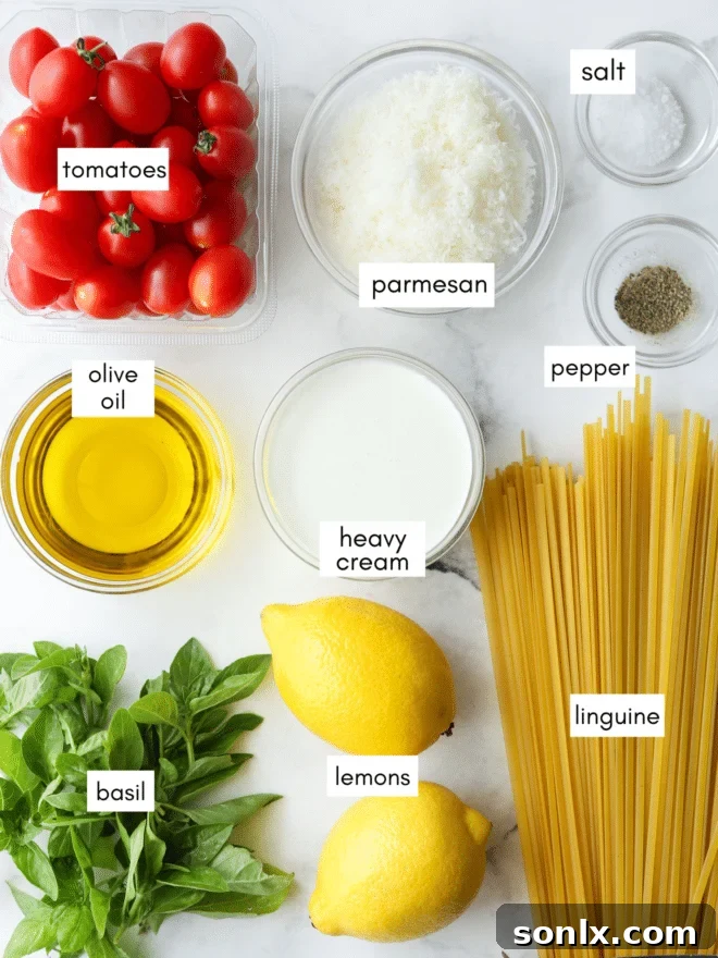 Fresh ingredients for lemon pasta including lemons, cherry tomatoes, fresh basil, Parmesan cheese, and olive oil.
