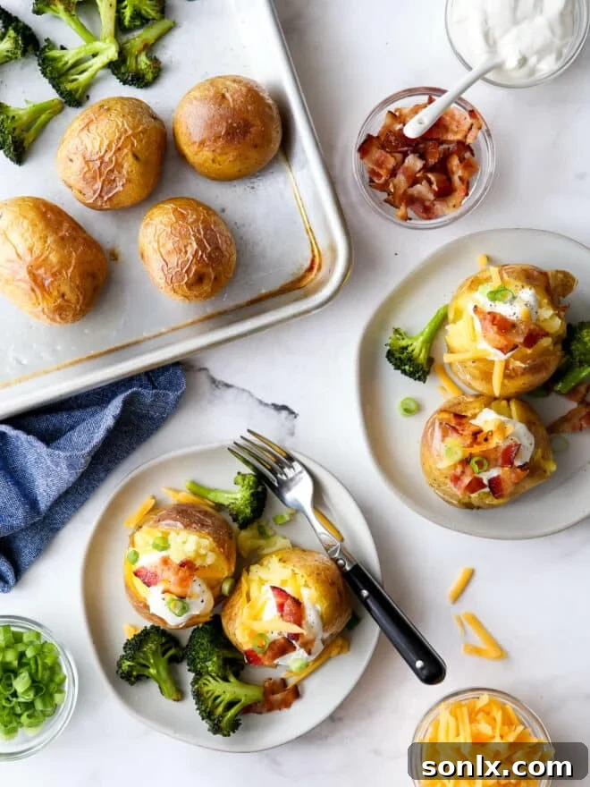 Plated servings of loaded baked potato with toppings, with the sheet pan visible in the background.