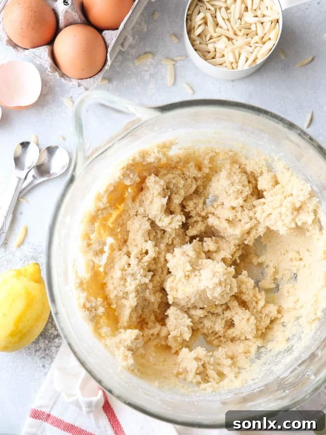 A stand mixer in action, mixing the butter, sugar, and other wet ingredients for the Linzer cookie dough.