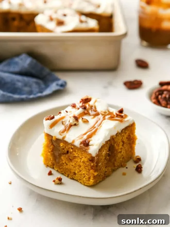 A delectable slice of homemade pumpkin caramel poke cake on a white plate, showcasing its moist texture, rich caramel seeped through, creamy whipped topping, and candied pecan garnish.