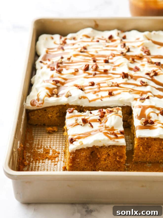 A tantalizing view of the caramel pumpkin poke cake, still in its baking pan, showing the rich caramel seeping into the cake's surface.