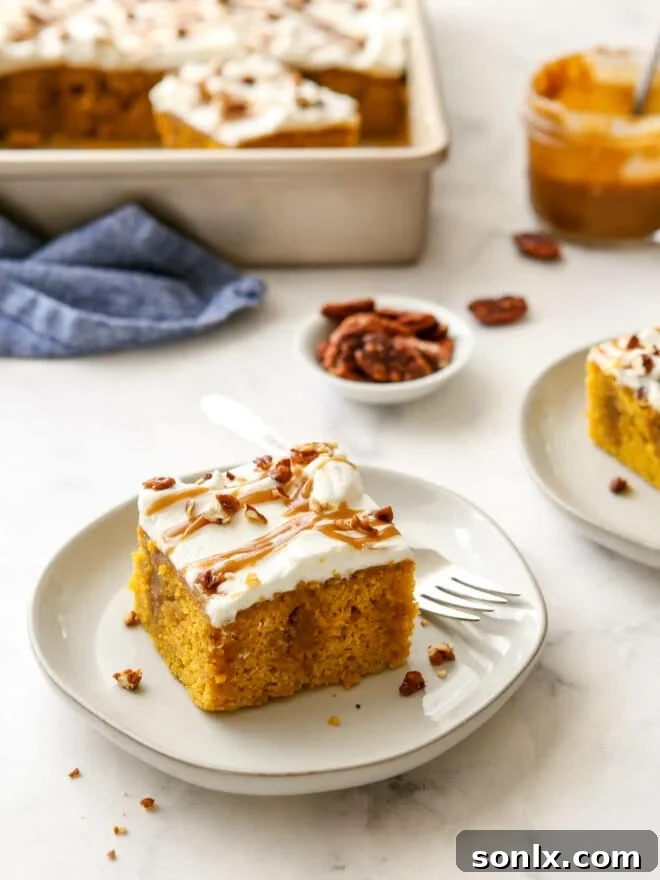 Multiple slices of pumpkin caramel poke cake served on individual white plates, ready to be enjoyed.