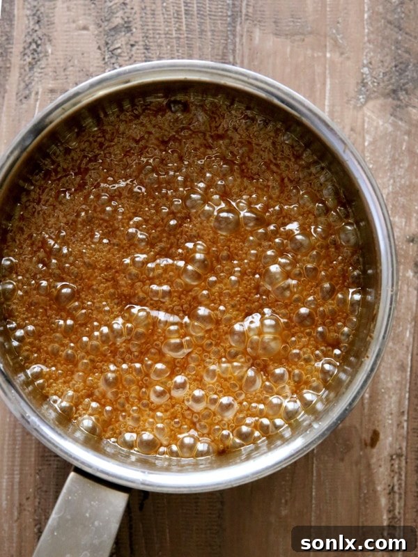 Homemade Apple Cider Caramel Sauce with a Spoon, Ready to Serve