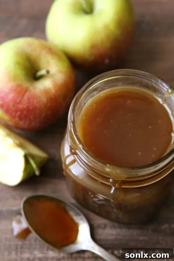 Delicious Apple Cider Caramel Sauce Dripping from a Spoon