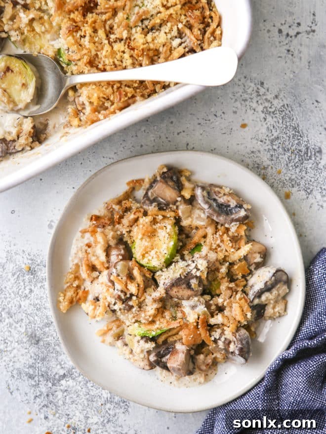 a serving of brussels sprout and mushroom casserole on a plate, ready to be enjoyed