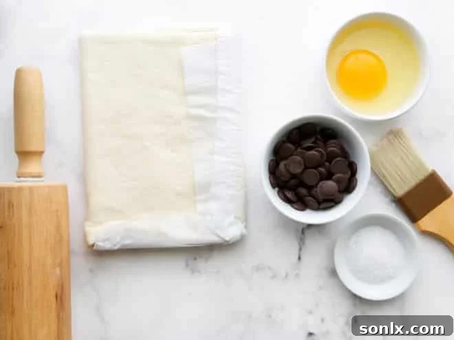 Just four ingredients laid out on a kitchen counter, ready for making puff pastry croissants