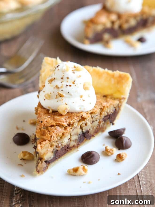 Slices of warm Toll House Cookie Pie topped with whipped cream, ready to be enjoyed.