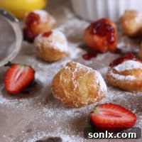 Lemon Cloud Puffs with Strawberry Blush 2 Delicious Lemon Beignets with Strawberry Sauce on a plate