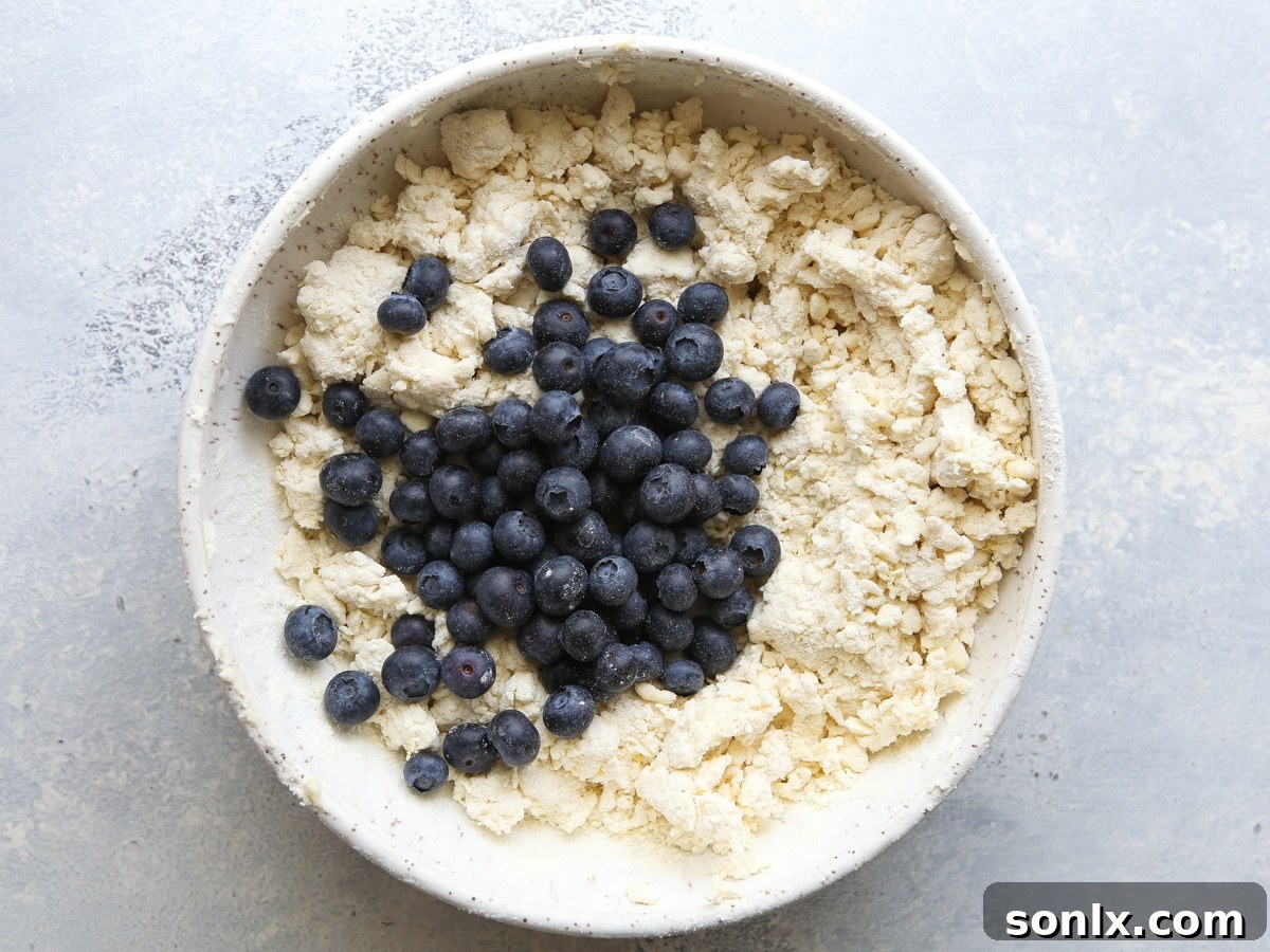 Cutting cold butter into flour mixture with a pastry blender