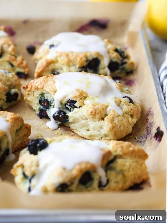 Perfectly baked lemon blueberry scones stacked on a plate