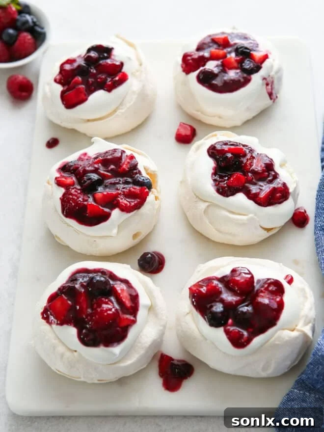 mini berry pavlovas on a serving platter, ready to be enjoyed