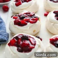 close up of mini berry pavlovas on a serving platter