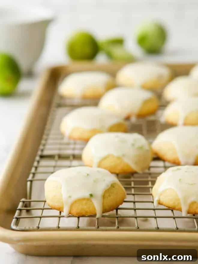 lime cornmeal cookies with icing on a wire rack, allowing the glaze to set