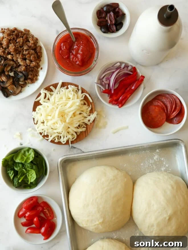 pizza dough and pizza toppings measured out and prepped on counter